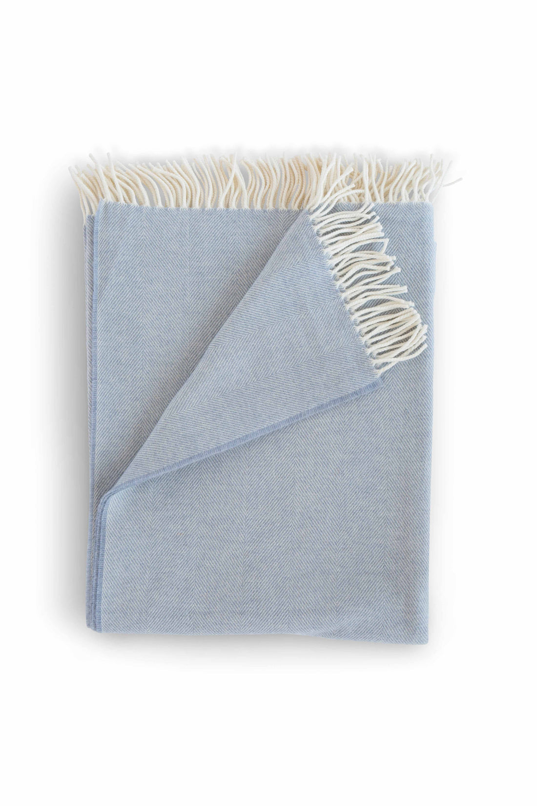 Evangeline Lightweight Herringbone throw with a tasseled edge in color Dawn, folded against a white background. The lighter weight 'sibling' to our popular Herringbone Throws.  Oh-so-soft. And perfect for summer nights.  