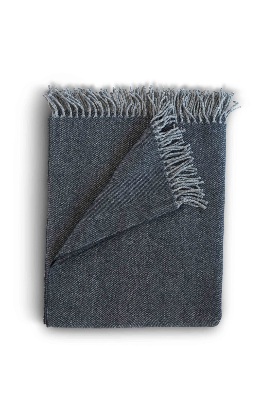 Evangeline Lightweight Herringbone throw with tasseled edge in Midnight, folded against a white background. The lighter weight 'sibling' to our popular Herringbone Throws.  Oh-so-soft. And perfect for summer nights.  