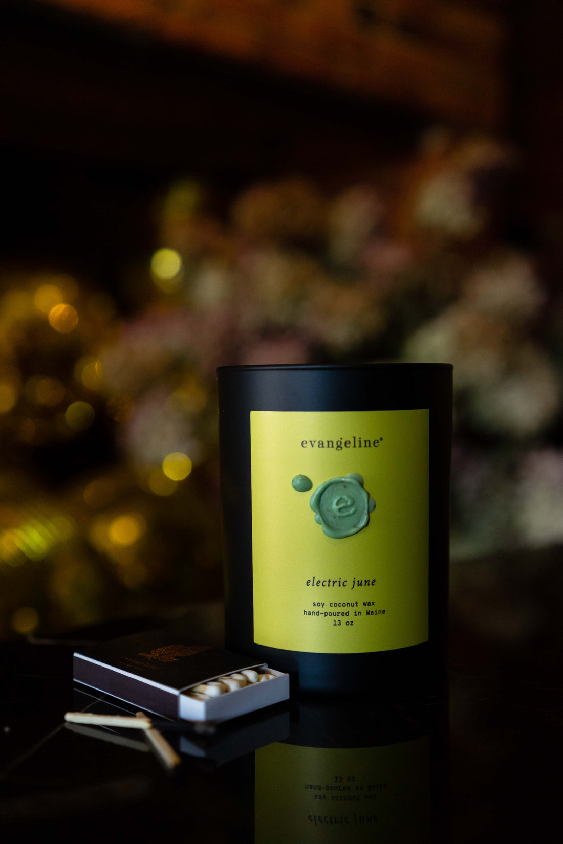 Soy coconut wax scented candle with cedar wood wick. Hand-poured in Portland Maine. Black matte glass jar, chartreuse label, mint green wax seal.