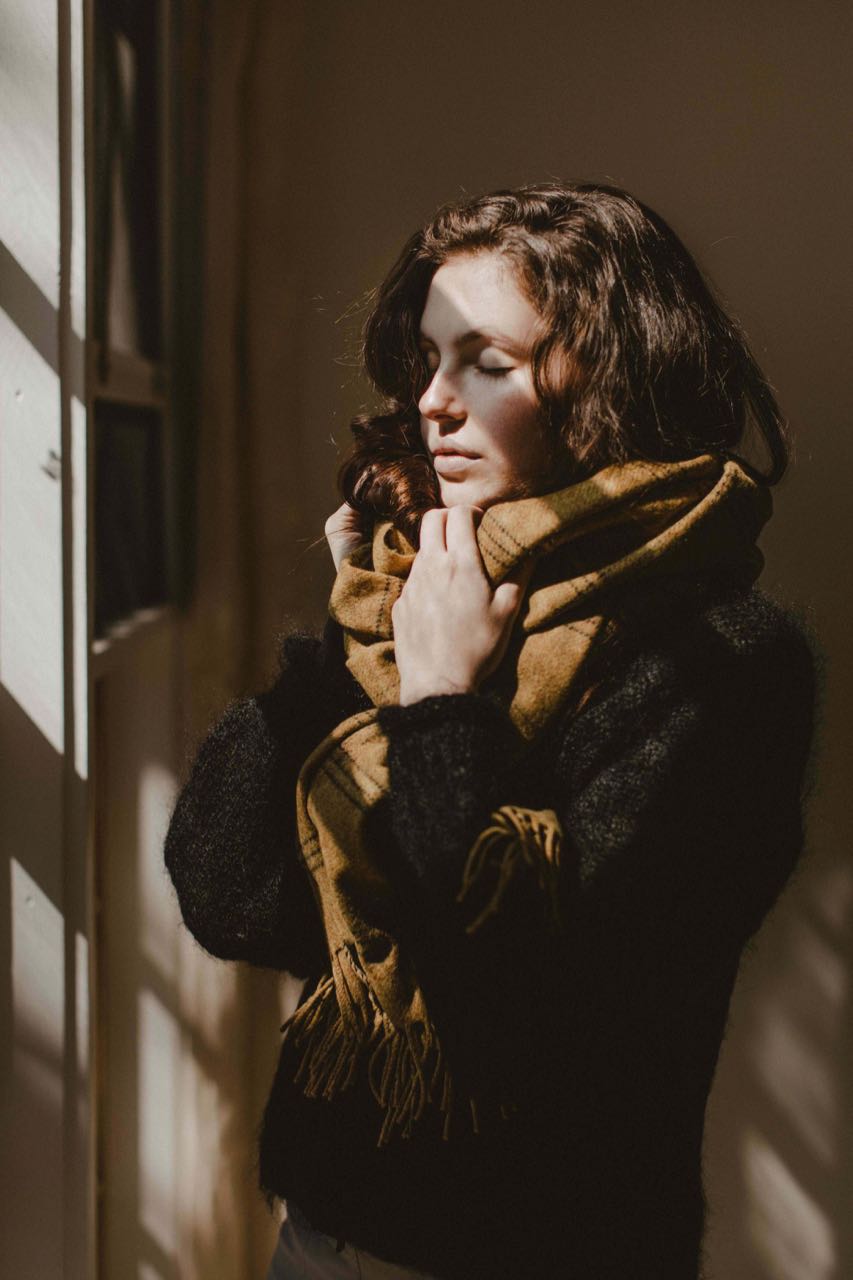 Woman wrapped up in wearable wrap windowpane burnt yellow