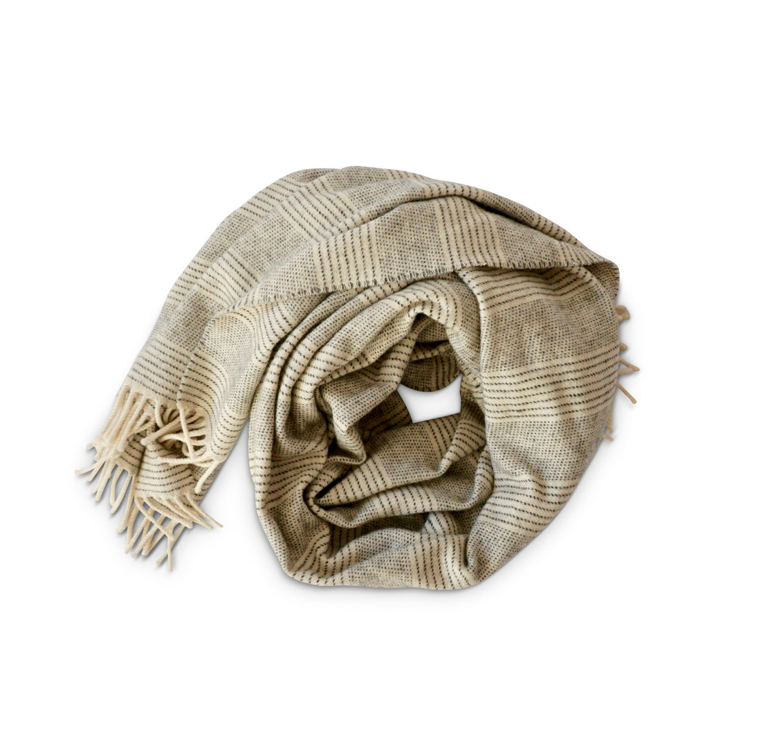 Evangeline Linens Merino Lambswool wearable wrap wrapped up, in cream and stripe graphite. Super soft, cozy and chic!